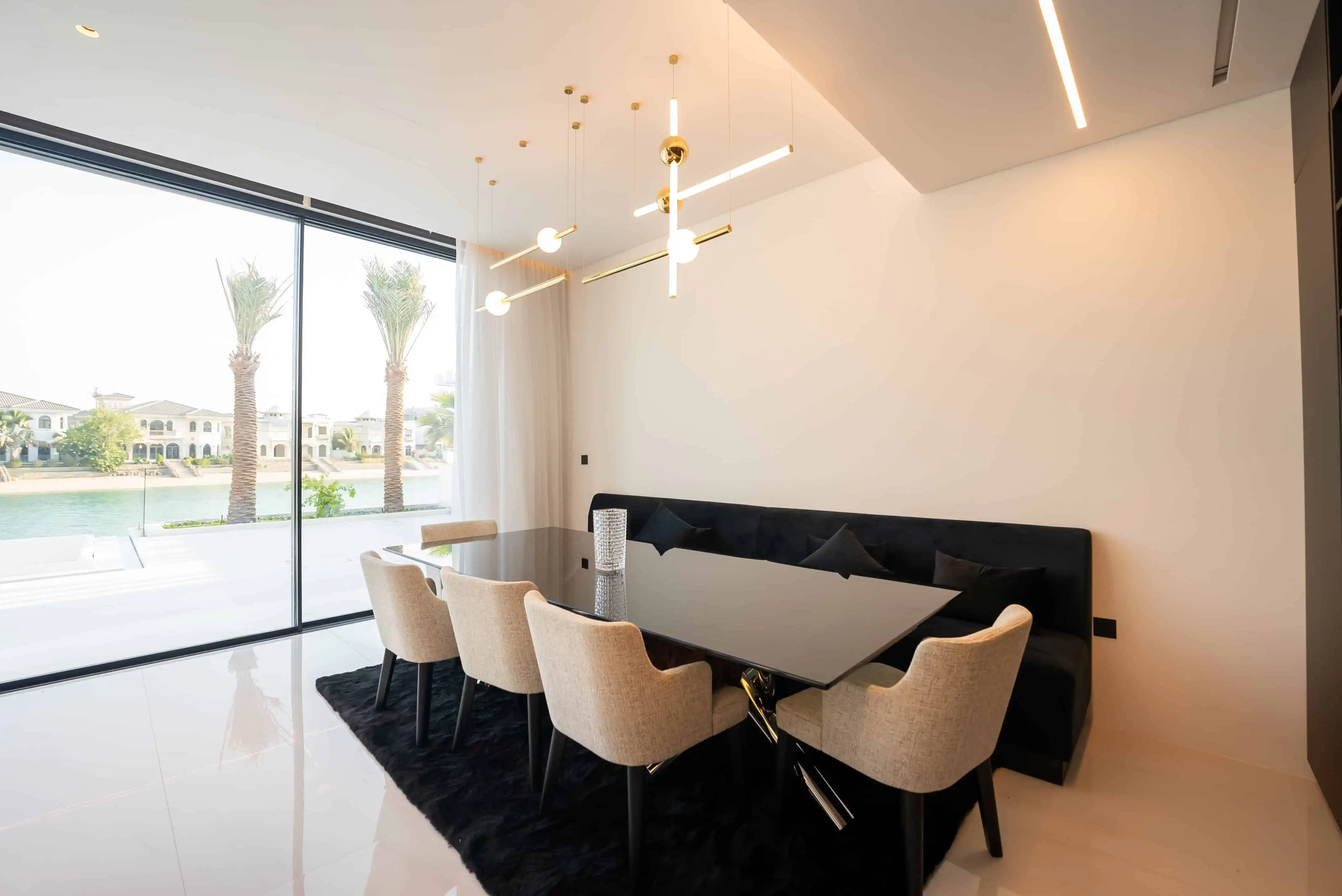 a dining table with chairs in a room with a glass wall