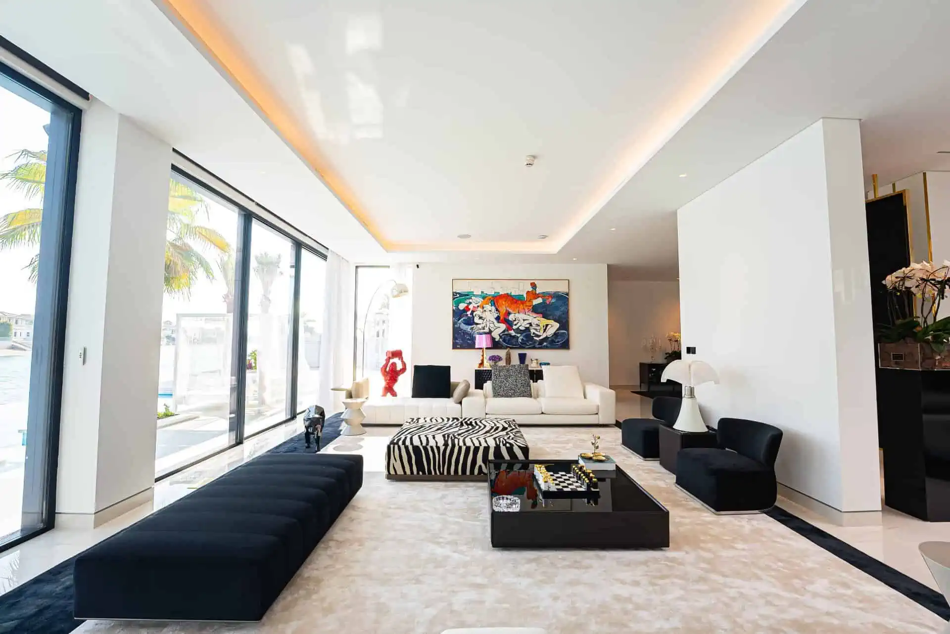 A living room with a black and white rug.