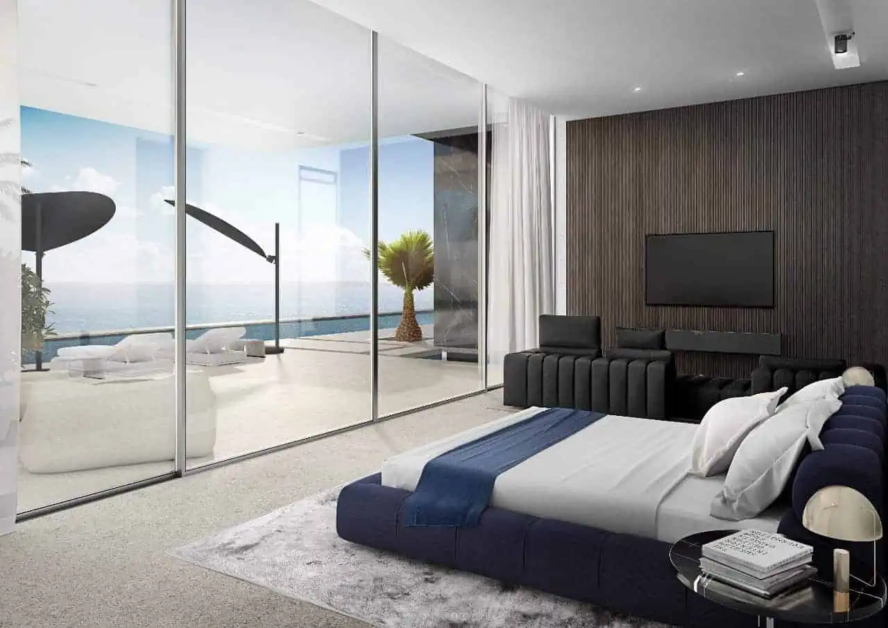 A modern bedroom with a large glass wall, offering a stunning view of the outside world.
