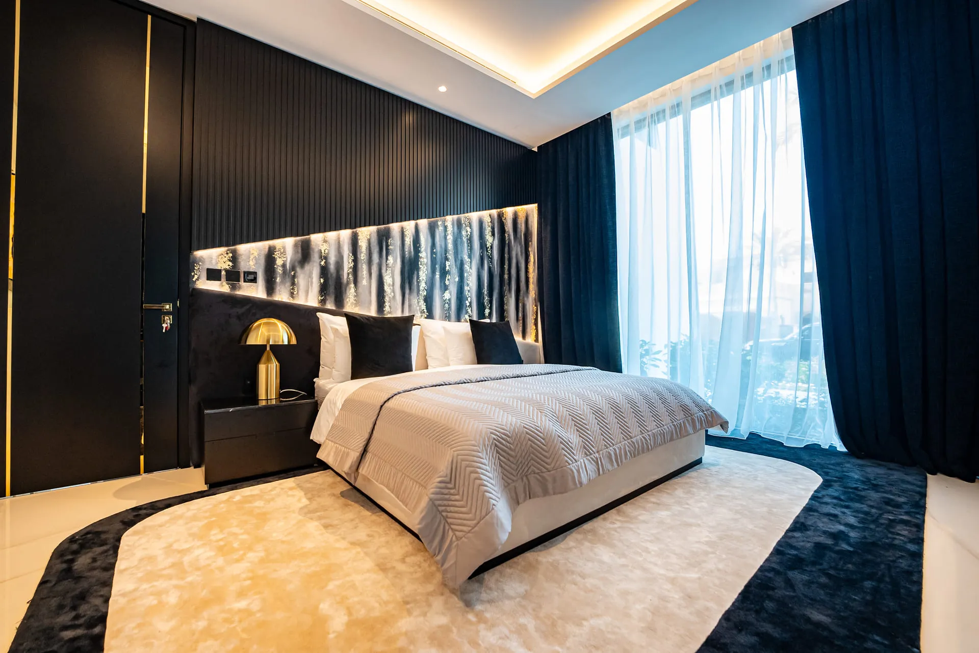 A stylish bedroom with elegant black and gold accents, creating a modern and luxurious ambiance.