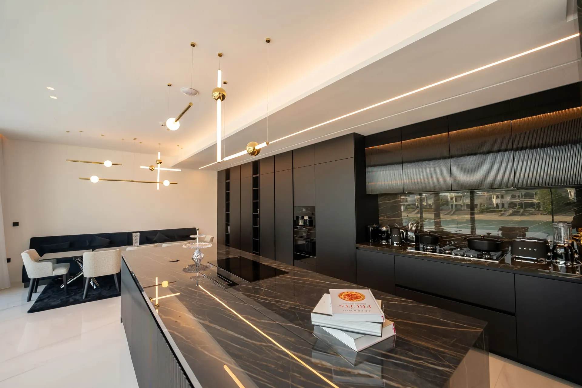 A sleek kitchen with black cabinets and marble counter tops, perfect for a contemporary home.