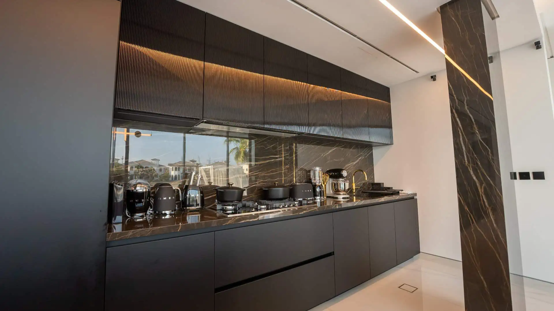 a kitchen with black cabinets and appliances