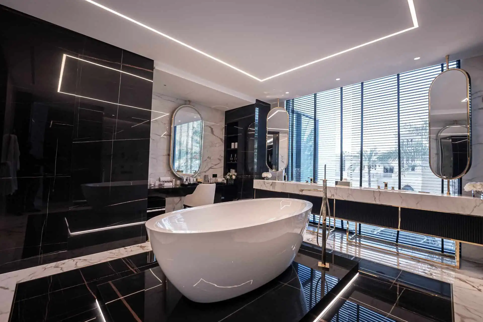 a bathroom with a bathtub, sink and few mirrors