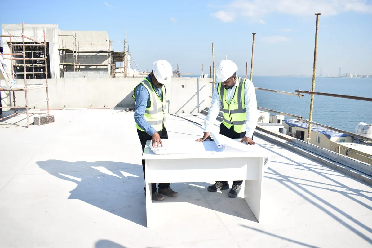 engineers discussing over a plan on construction site.