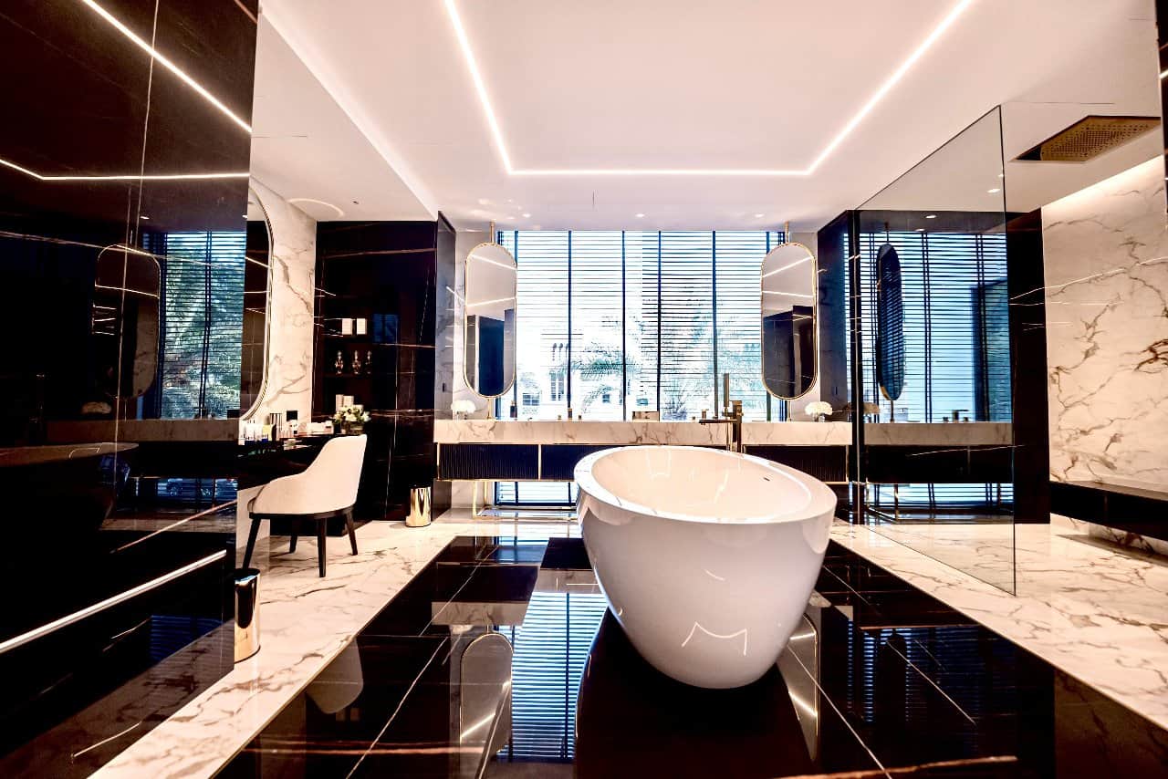 a bathroom with a tub and a mirror