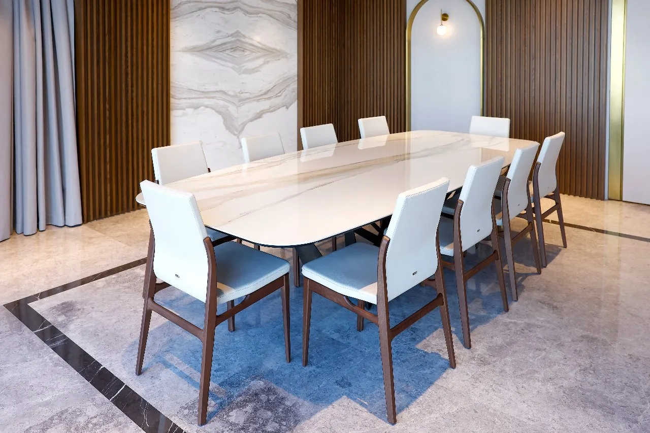 A contemporary dining room adorned with a luxurious marble table and stylish chairs, creating a sophisticated ambiance.
