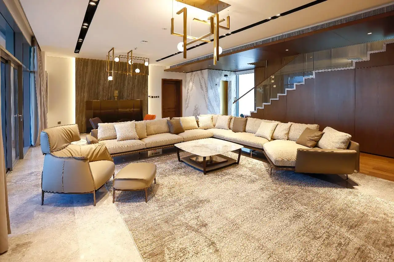 A cozy living room with a spacious sectional sofa and a stylish coffee table. Perfect for relaxation and entertaining guests.