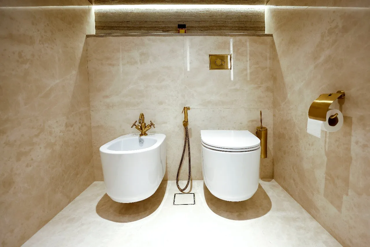 A bathroom with a toilet and bidet, providing comfort and convenience for personal hygiene needs.