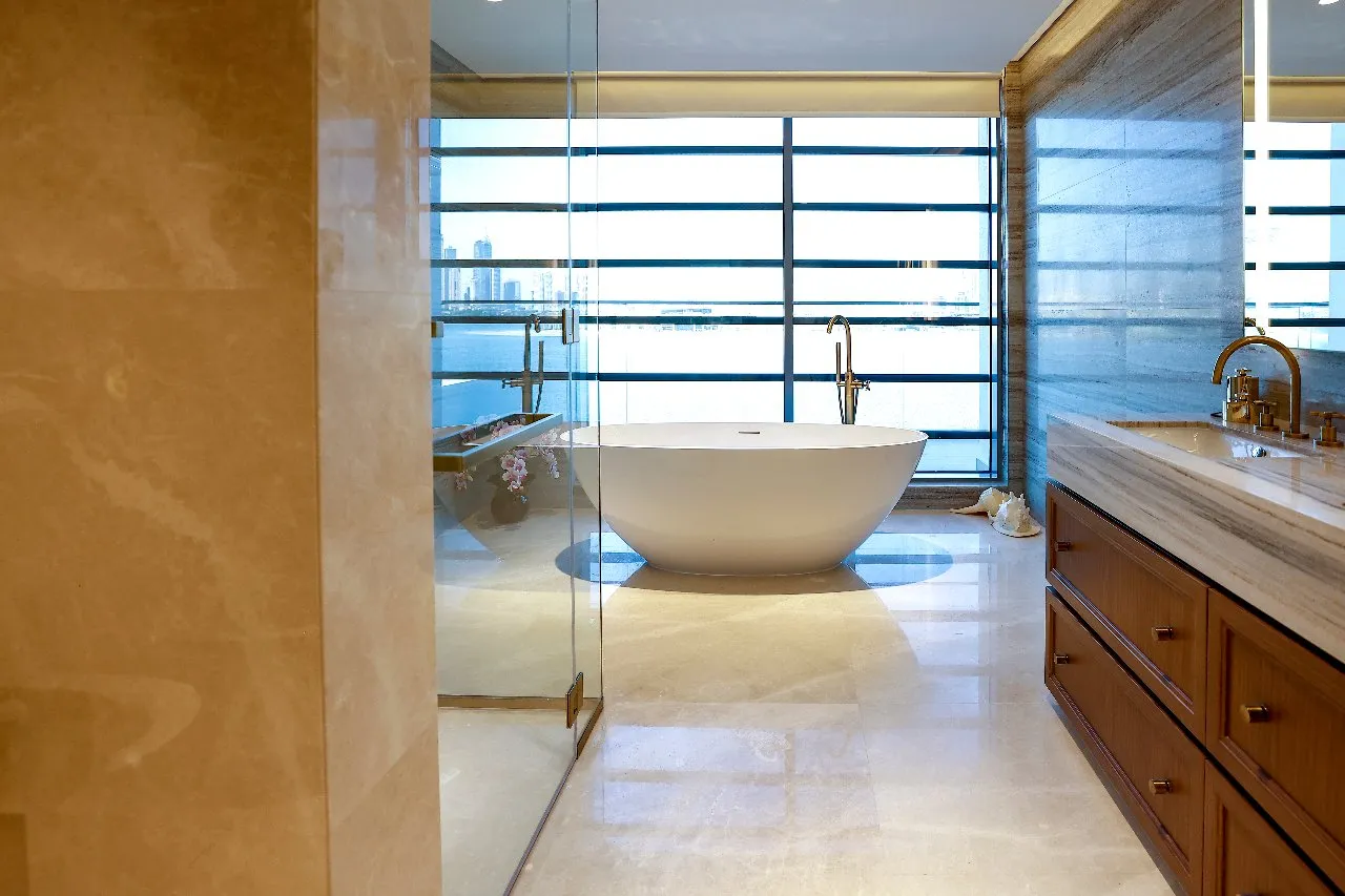 A spacious bathroom with a big tub and a large mirror, perfect for relaxation and getting ready.