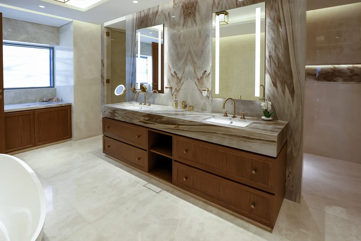 A spacious bathroom with a double sink and a relaxing tub. Perfect for unwinding and getting ready for the day ahead.
