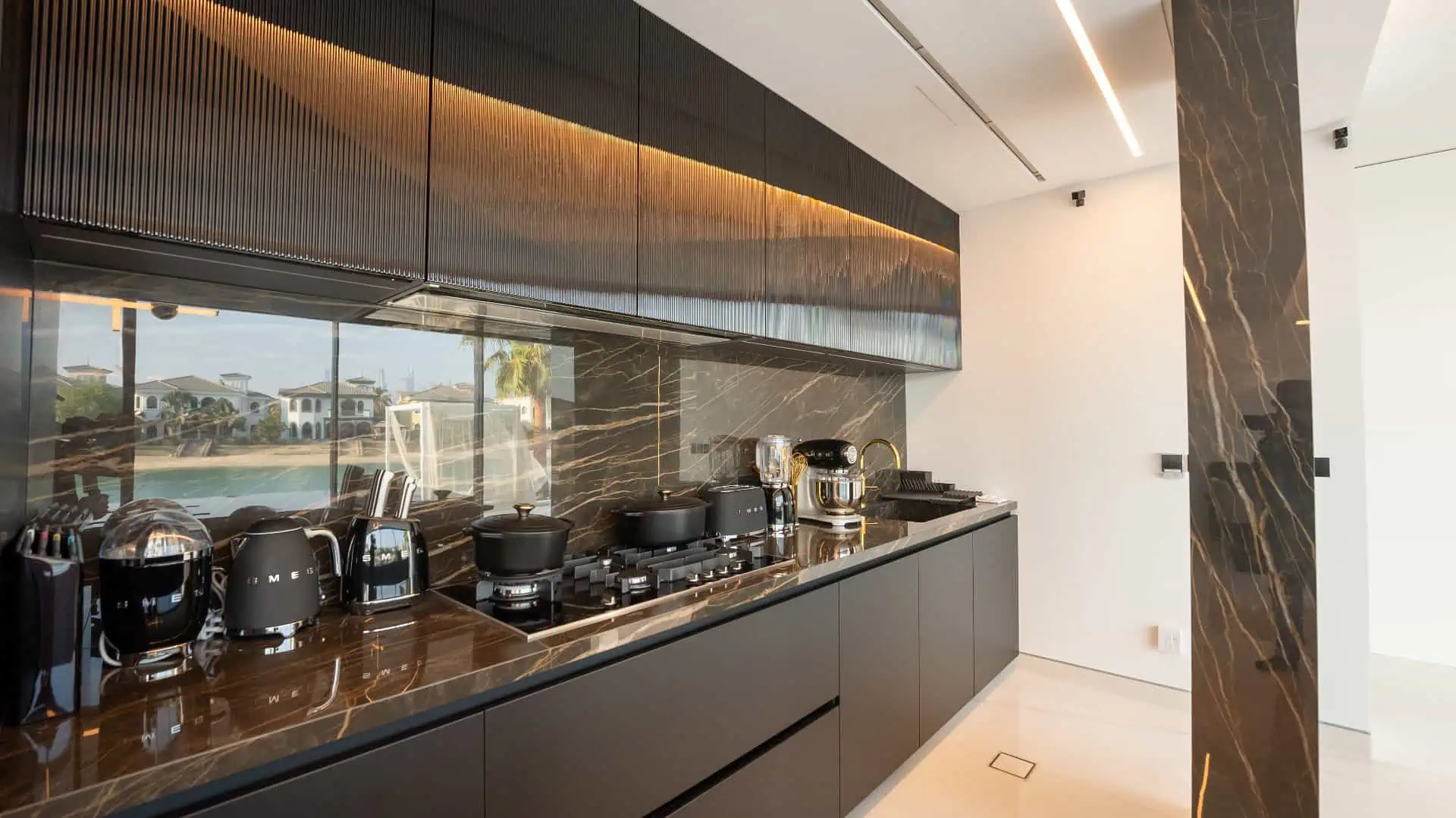 a kitchen with black cabinets and appliances